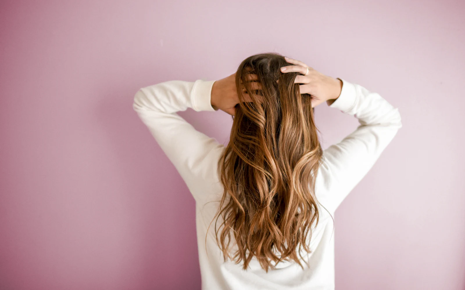 Wide view of long hair with caramel color through the mid-lengths and ends