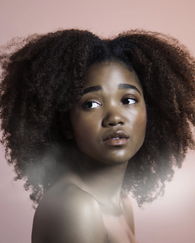 Portrait of a woman with dense curly hair